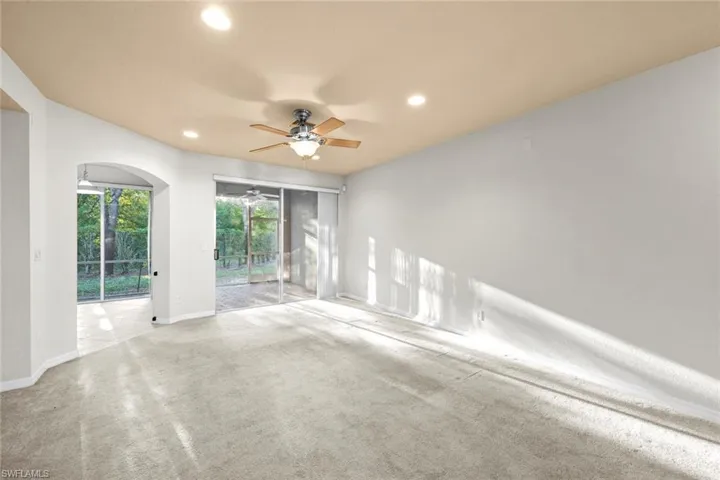 Carpeted spare room with ceiling fan