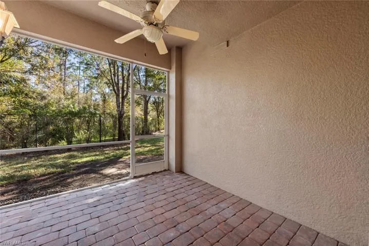 Unfurnished sunroom with ceiling fan