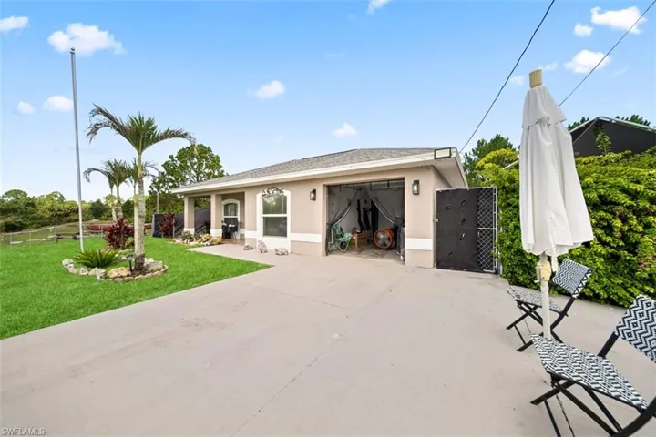 Single-story residence featuring a neutral-toned exterior, concrete driveway, and a covered front entry