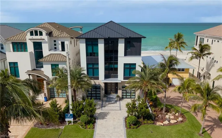 View of property with a water view and driveway