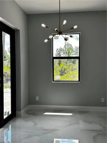 Dining area with custom gold light fixture
