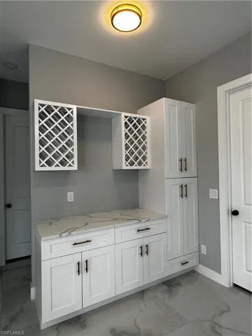 Bar area with custom cabinets, pantry and wine shelves