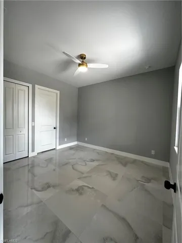 Master bedroom with gold detail remote controlled ceiling fan