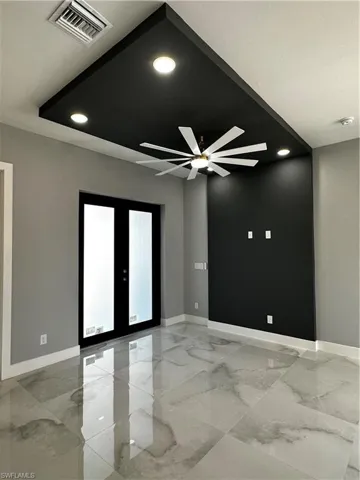 Custom tray ceiling detail in entrance with remote controlled ceiling fan