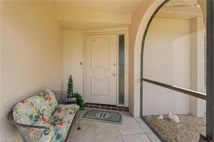 Doorway to property featuring stucco siding