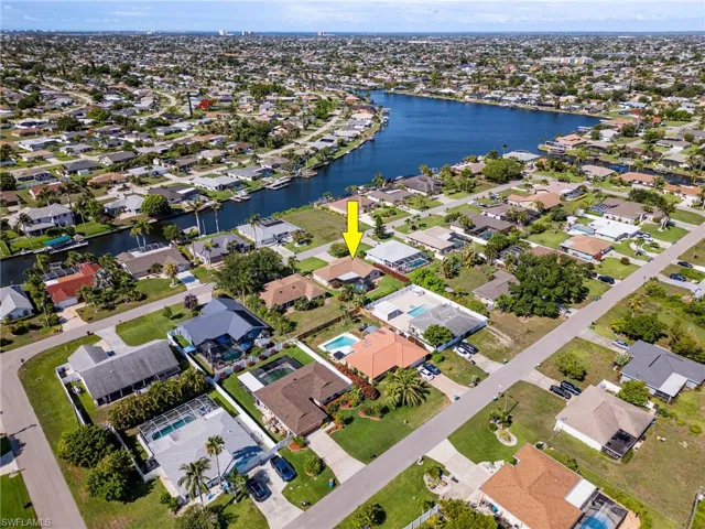 Aerial overview of property's location featuring a nearby body of water and nearby suburban area