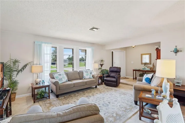 Living area featuring a textured ceiling and baseboards