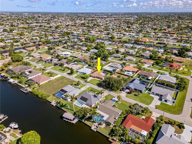 Aerial perspective of suburban area featuring a nearby body of water