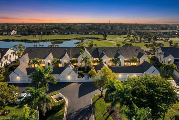 Aerial view of property and surrounding area with a nearby body of water, nearby suburban area, and a local golf course
