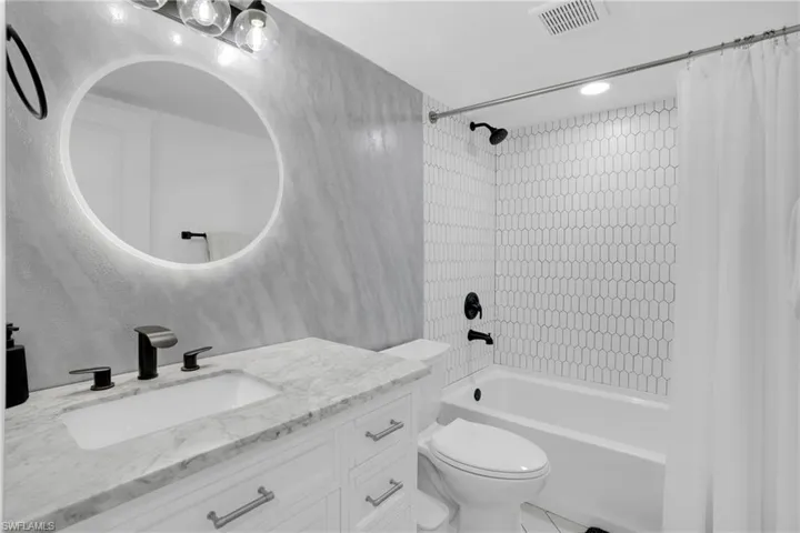 Full bath with shower / bathtub combination with curtain, vanity, and recessed lighting