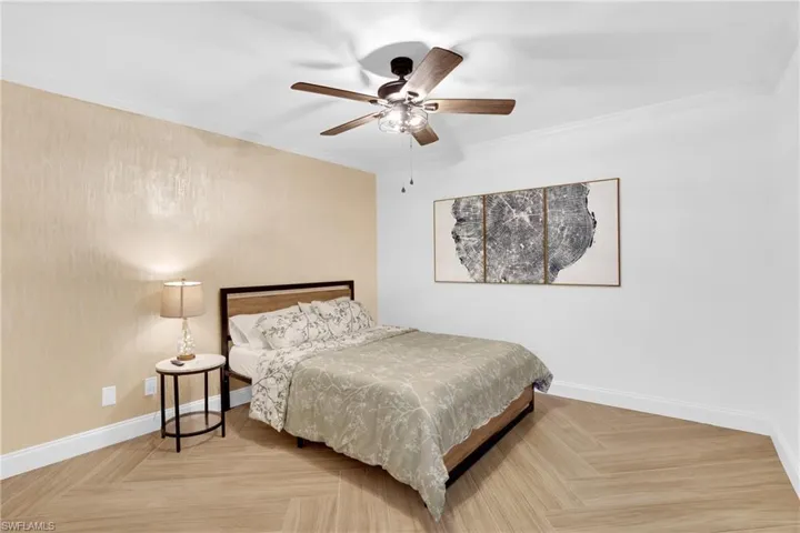 Bedroom with crown molding and ceiling fan
