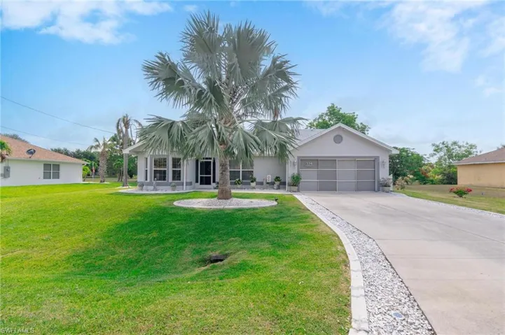 Ranch-style home with two car screened garage and mature landscaping