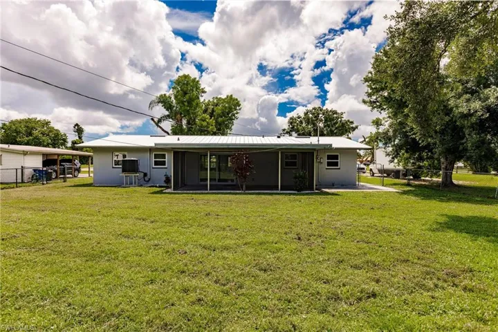 Back of house with a lawn