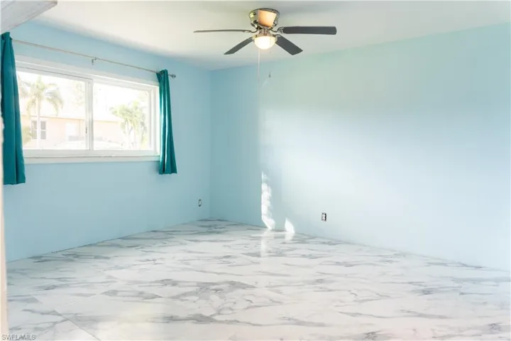 Unfurnished room featuring ceiling fan