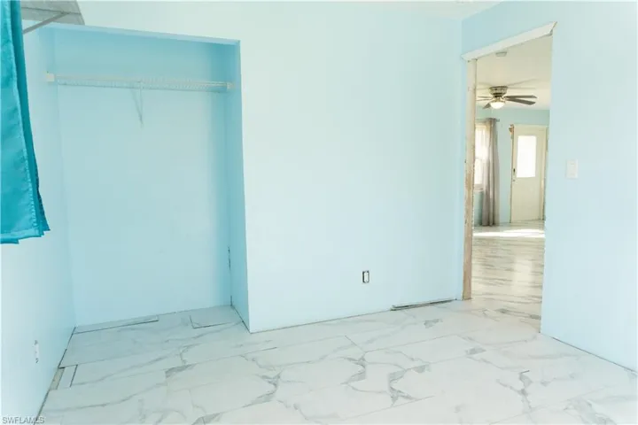 Unfurnished bedroom with a closet and ceiling fan