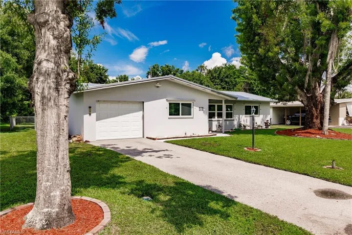 Ranch-style home with a garage and a front lawn