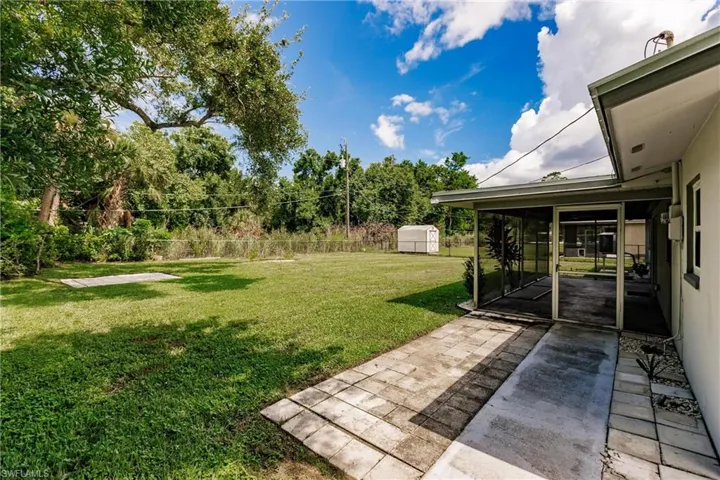 View of yard featuring a patio and a shed
