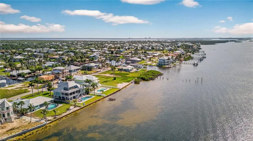 Aerial perspective of suburban area with a nearby body of water