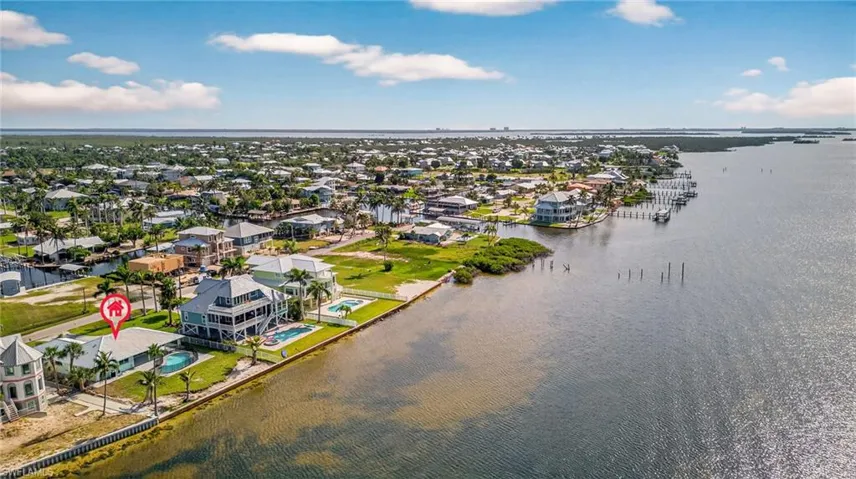 Aerial perspective of suburban area featuring a large body of water