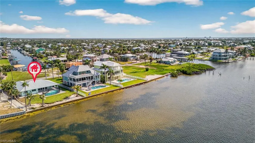 Aerial perspective of suburban area featuring a large body of water