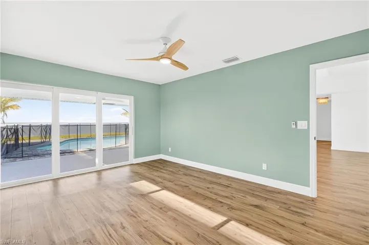Empty room featuring wood finished floors and a ceiling fan