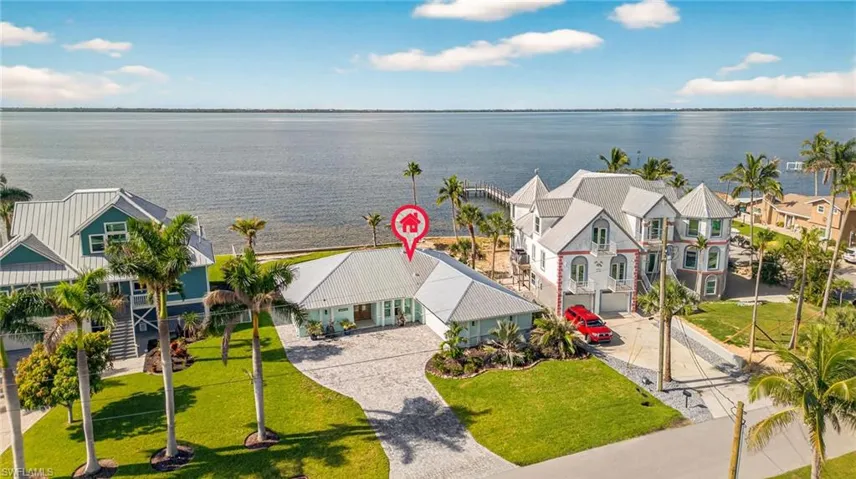 Aerial perspective of suburban area featuring a large body of water