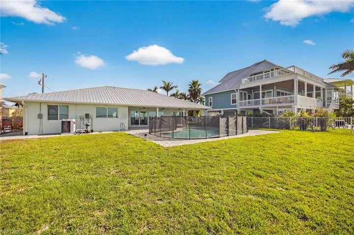 Back of house with a patio, a metal roof, and stucco siding