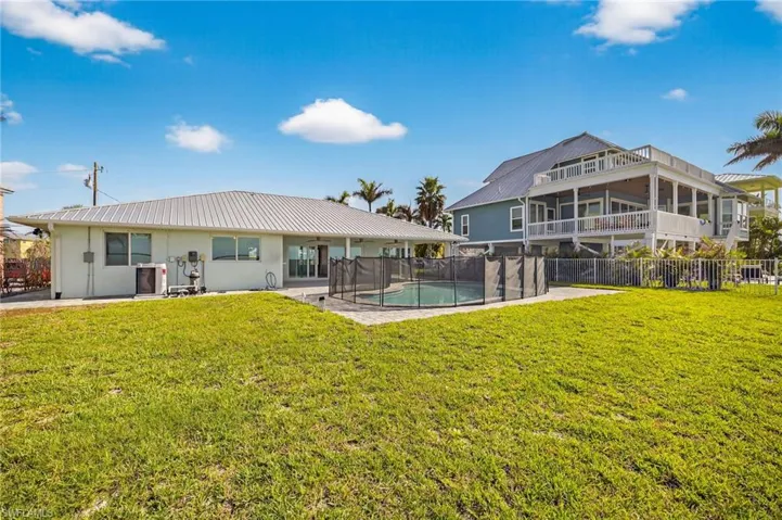 Back of house with a metal roof, a patio, and stucco siding