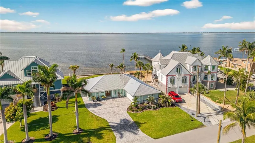 Aerial view of residential area featuring a large body of water