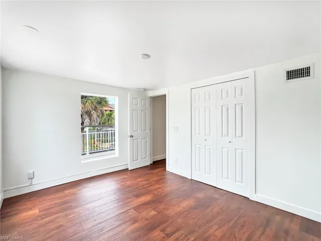 Second Upper Level bedroom featuring a closet and dark wood-type flooring