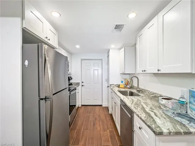 Galley Kitchen with stainless steel appliances, and sink