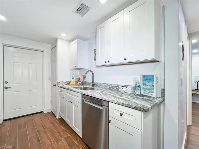 Kitchen with ceramic flooring and door to private fenced rear yard