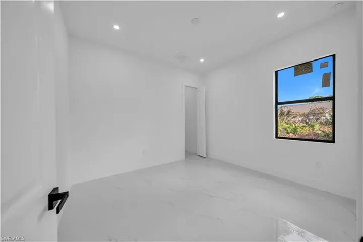 Unfurnished room with recessed lighting and light marble finish flooring