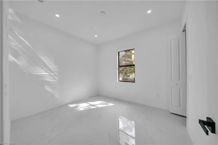 Spare room with recessed lighting and light marble finish flooring