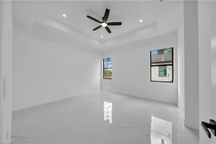 Spare room with a ceiling fan, recessed lighting, and finished concrete floors