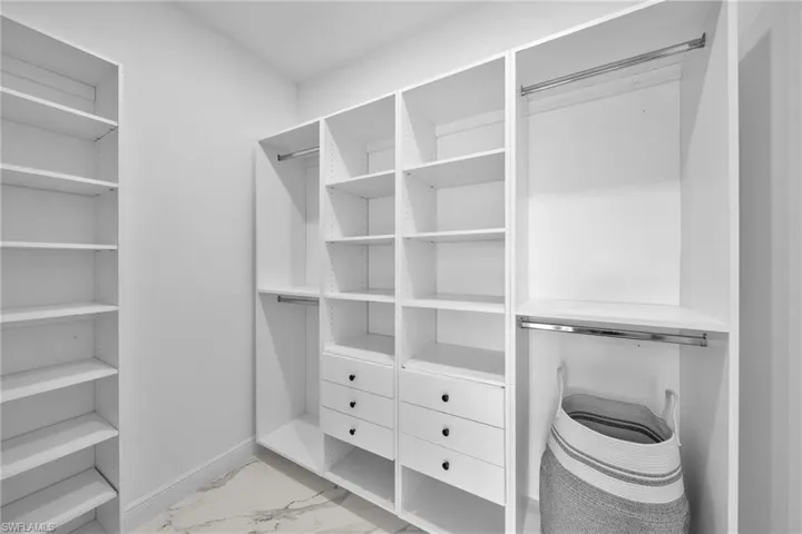 Spacious closet with light marble finish flooring