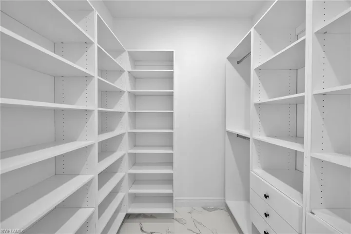 Spacious closet with marble look tiles