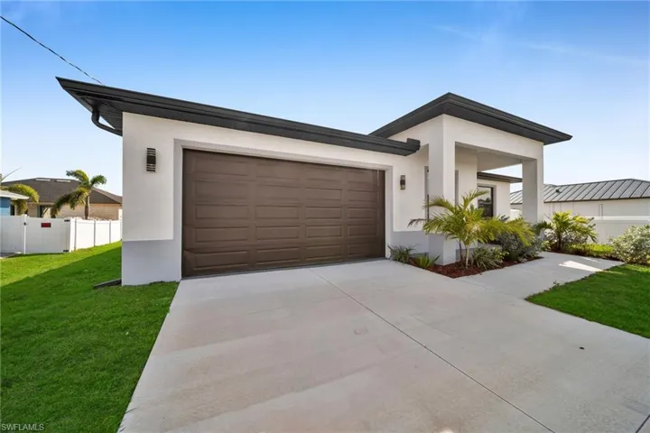Contemporary home with stucco siding, driveway, and a garage