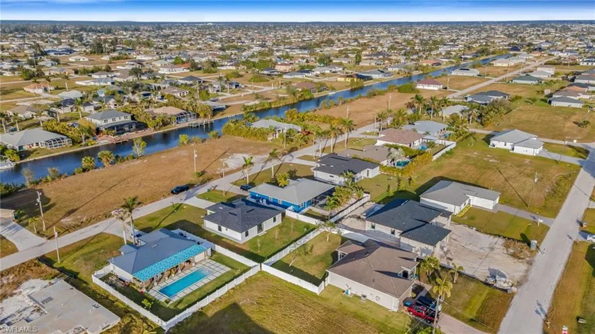 Aerial overview of property's location with nearby suburban area and a nearby body of water