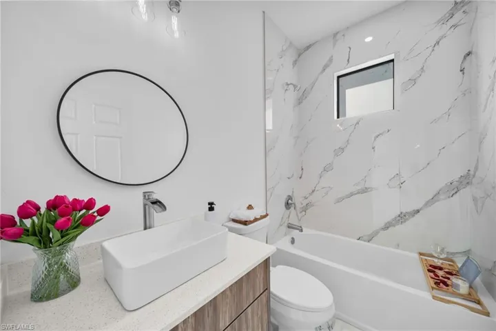 Bathroom featuring vanity, toilet, and shower / bath combination