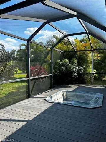 View of pool with a hot tub