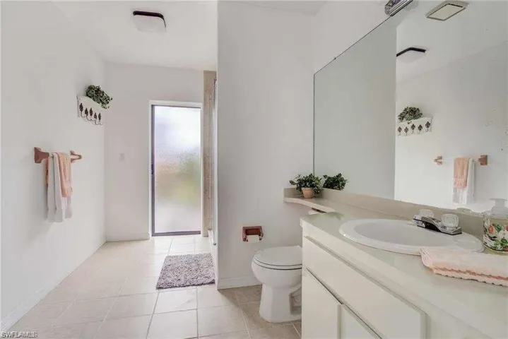 Bathroom featuring tile patterned floors, vanity, and toilet