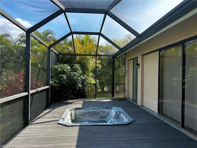 Unfurnished sunroom with a jacuzzi