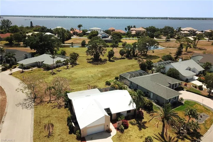 Birds eye view of property with a residential view and a water view