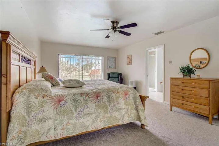 Bedroom featuring ceiling fan and carpet floors