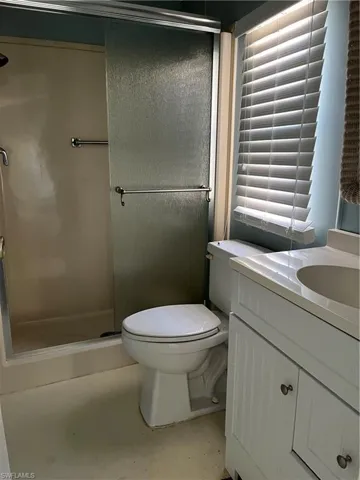 Full bathroom with vanity and a stall shower