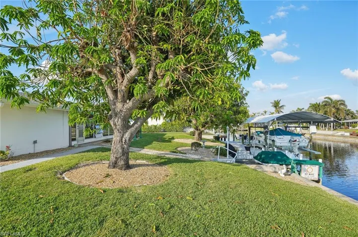 View of yard featuring a water view and a dock
