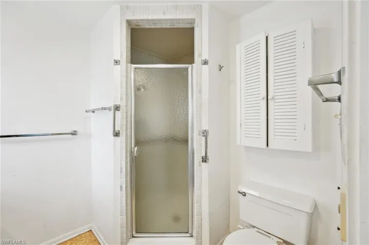 Bathroom with an enclosed shower and toilet