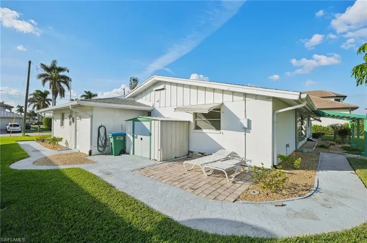 Rear view of house featuring a lawn and a patio area