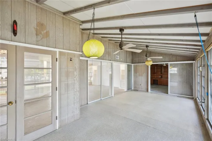 Garage featuring wood walls and ceiling fan